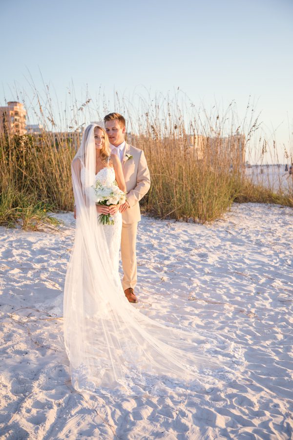 the bride and groom at the beach