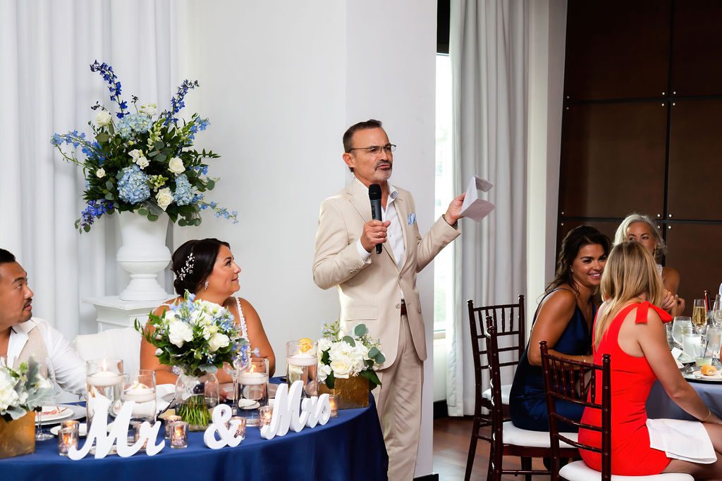 a man speaking at the wedding reception