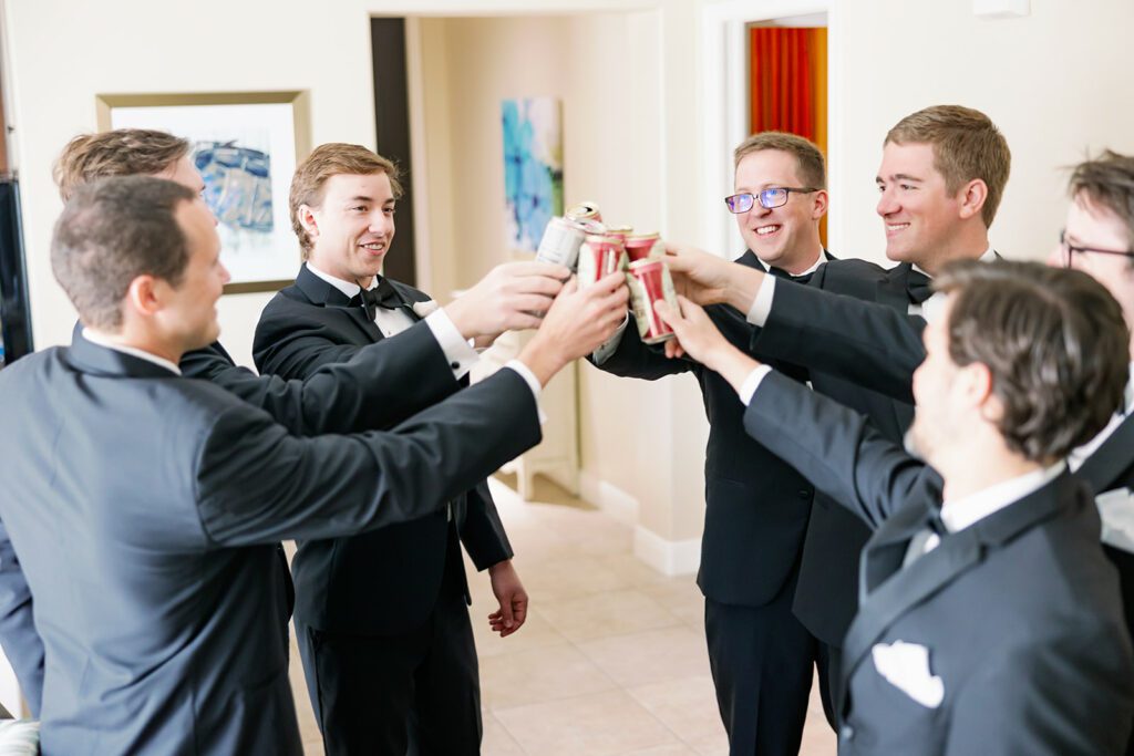 the groom and his entourage holding up their drinks